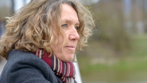 Foto von lockiger Frau mit Schal im Profil im Freien