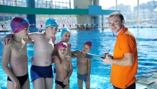 Foto von Kindern mit Badekappe im Schwimmbad